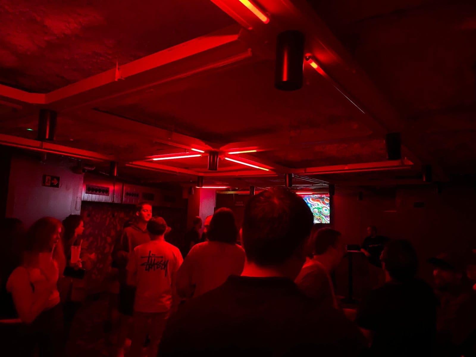 The same basement in red during a party