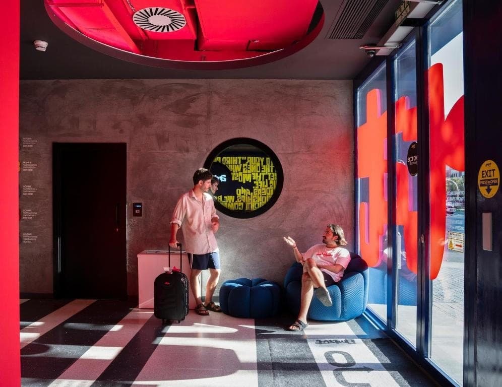 Lobby with a red ceiling and a small circular LED screen