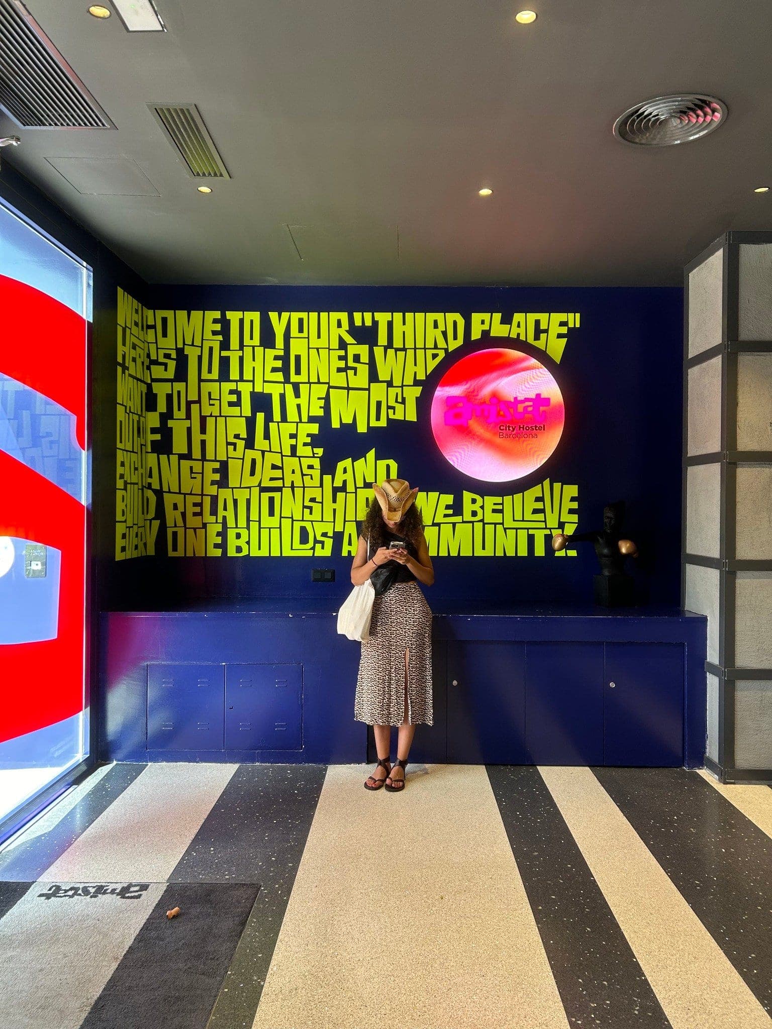 Circular LED screen set into a painted manifesto wall