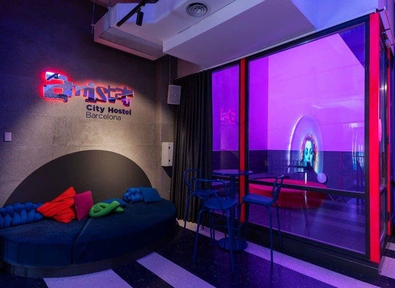 Lounge with a neon sign facing the main screen