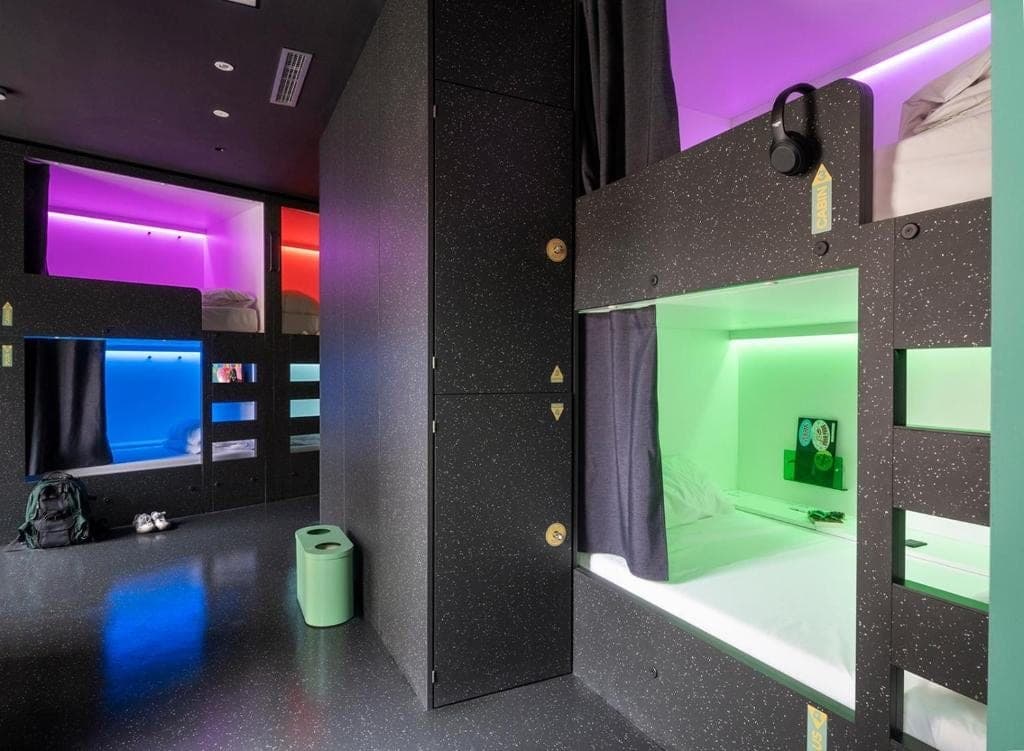 Bunk pods each lit in a different colour