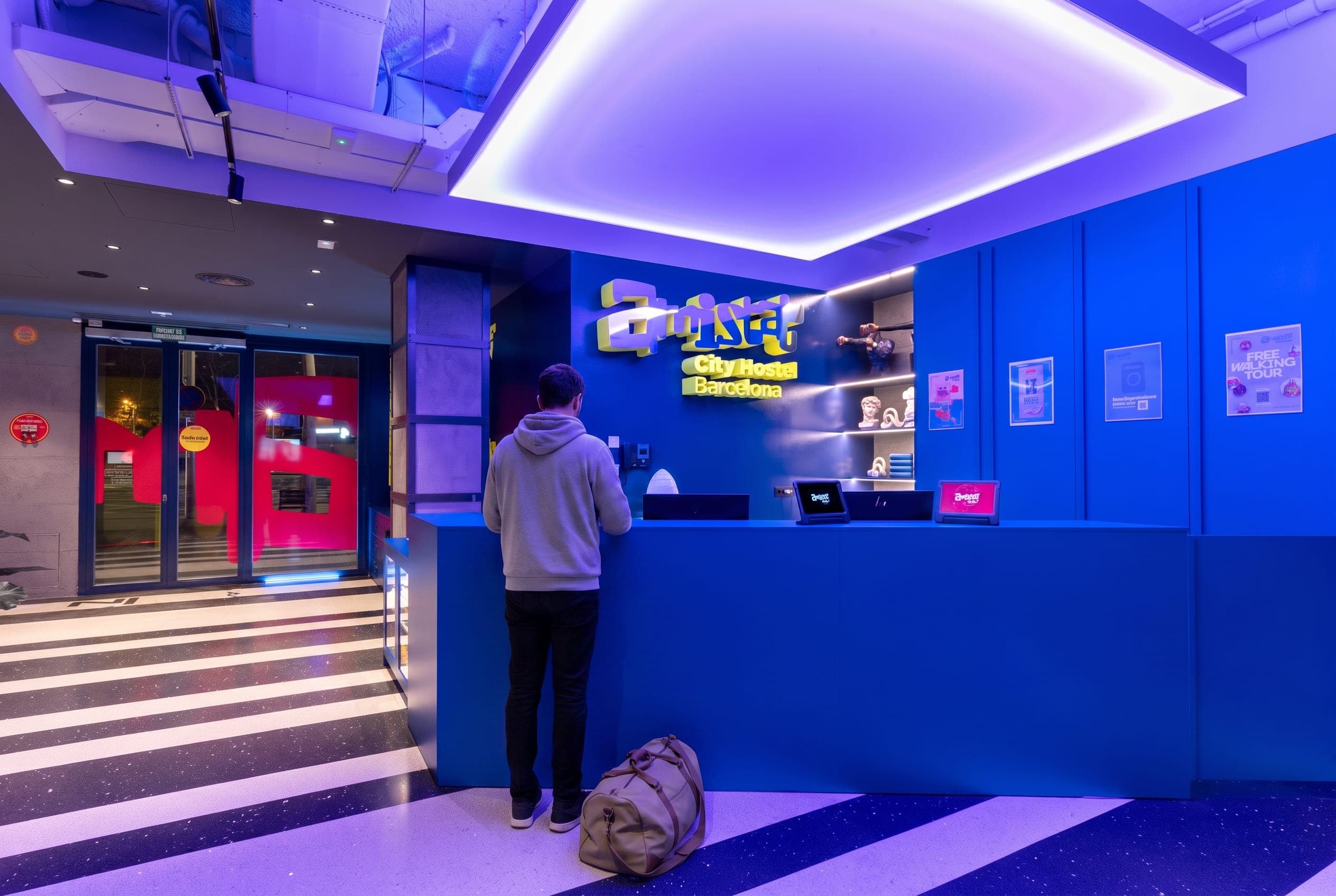 Blue reception desk under a large light ceiling