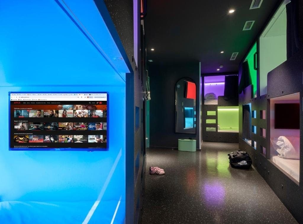 Room with a wall screen and coloured pods
