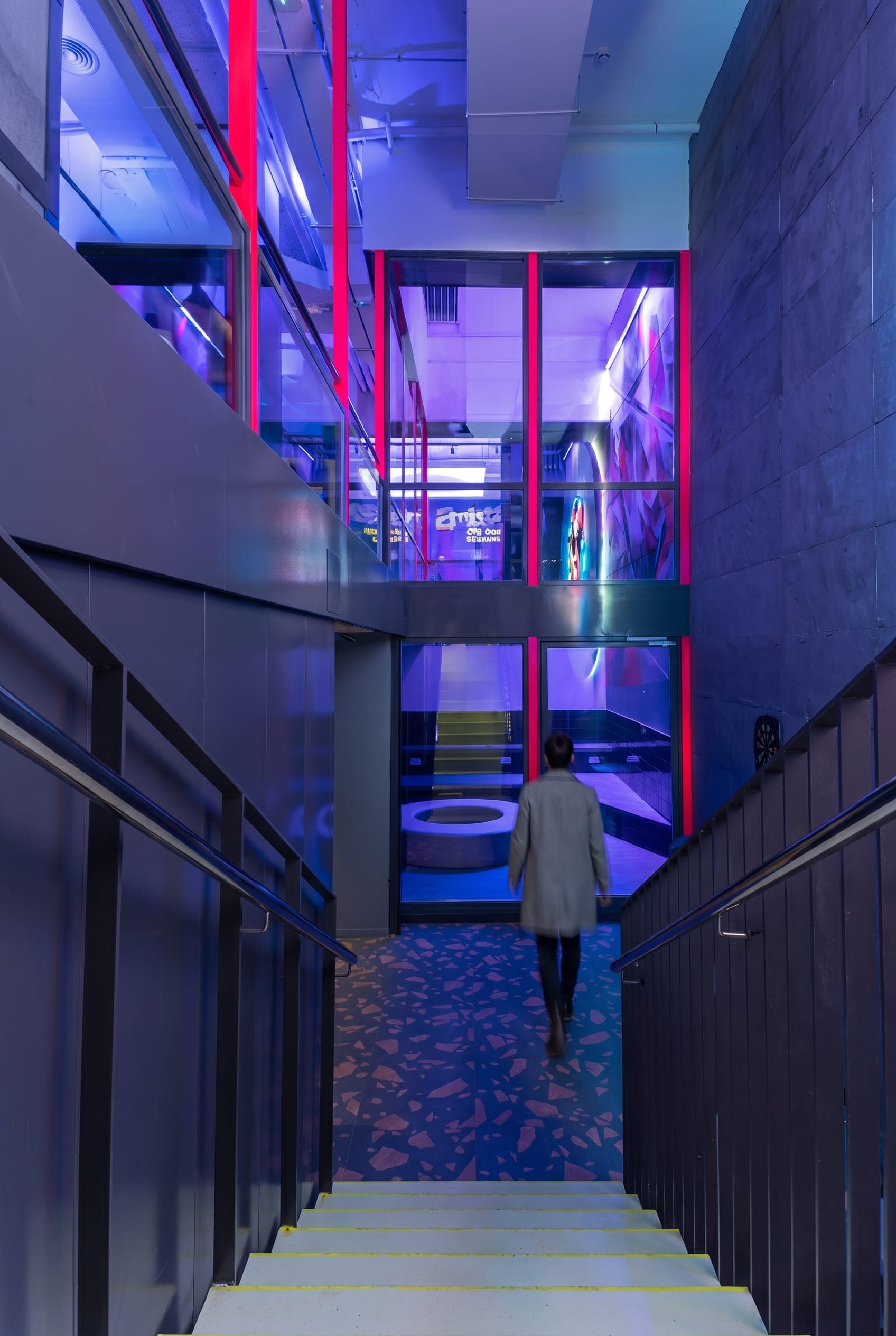 Stairwell opening onto stacked interior terraces