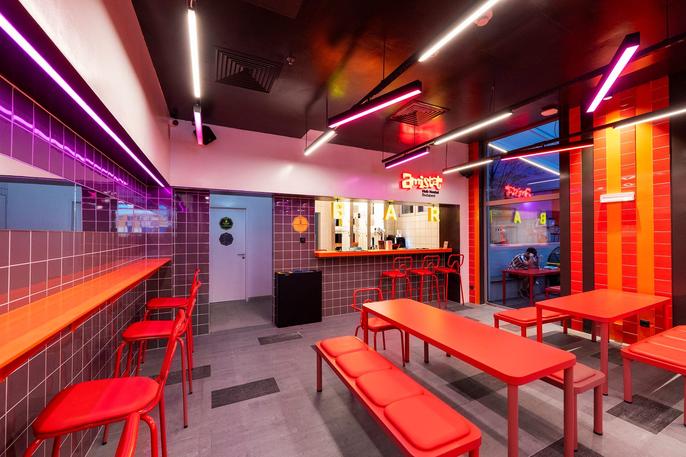 Bar with red bench, purple tile and the amistat neon