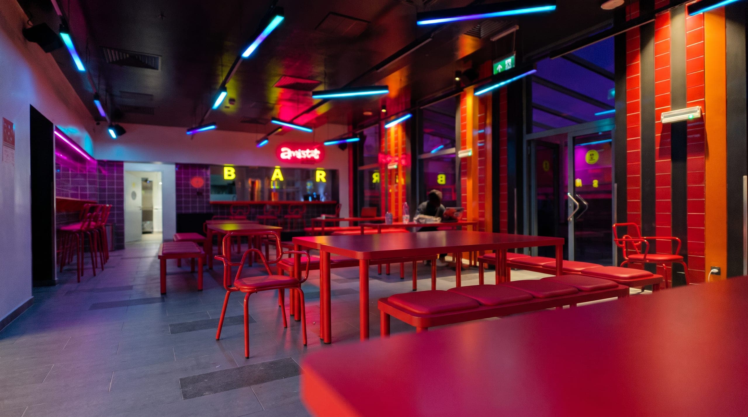 Wide view of the bar with a guest at the counter